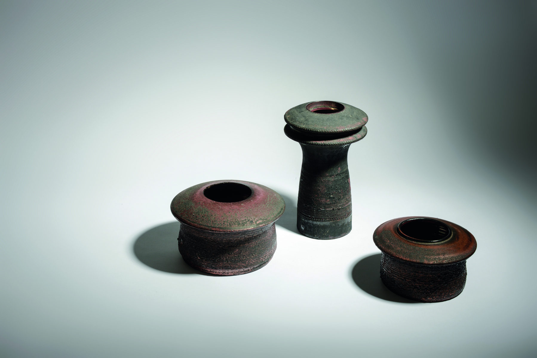 Aerial view of fiery red glazed ceramic pot, amphora Rogier Vandeweghe Ceramics 1957-1975 in white font near centre