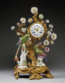 Book cover of Hidden Valuables: Early-Period Meissen Porcelains from Swiss Private Collections, featuring with two men in Chinese dress on top of gold ornate plinth with exotic trees and flowers. Published by Arnoldsche Art Publishers.