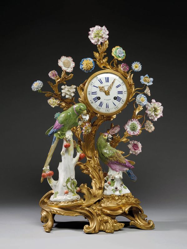 Book cover of Hidden Valuables: Early-Period Meissen Porcelains from Swiss Private Collections, featuring with two men in Chinese dress on top of gold ornate plinth with exotic trees and flowers. Published by Arnoldsche Art Publishers.