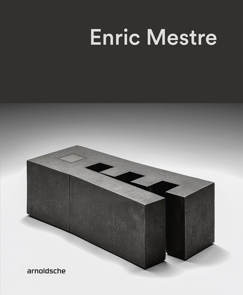 Black stoneware brick sculpture, on white cover, Enric Mestre in white font above.