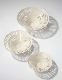 Collection of cream and black cups, saucers and vases, on white and grey cover, of 'Doris Bank, Table Art in Stoneware and Porcelain', by Arnoldsche Art Publishers.