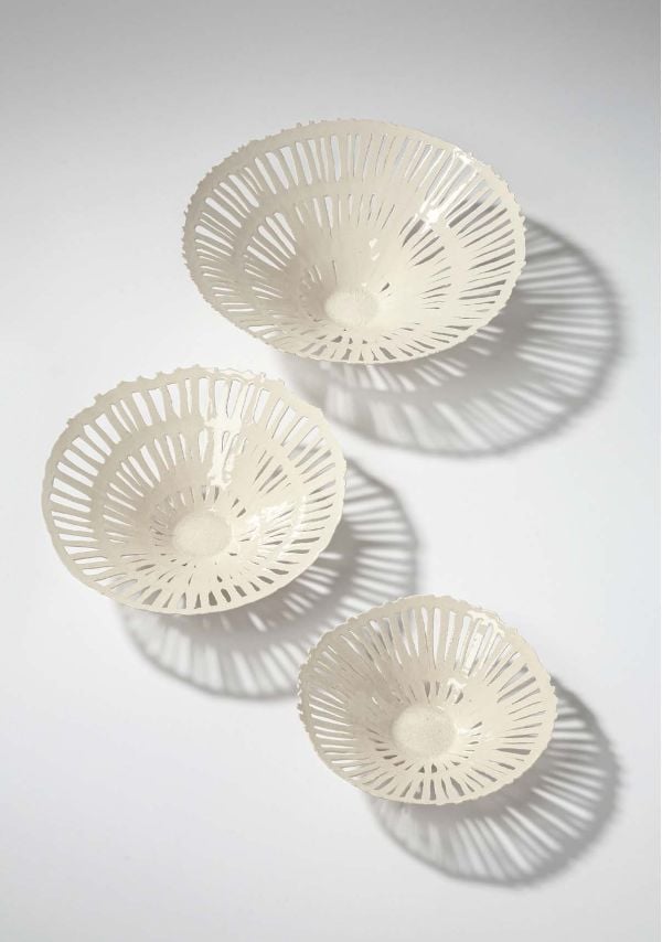 Collection of cream and black cups, saucers and vases, on white and grey cover, of 'Doris Bank, Table Art in Stoneware and Porcelain', by Arnoldsche Art Publishers.