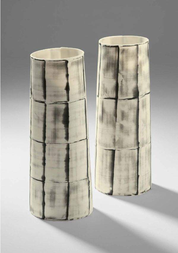 Collection of cream and black cups, saucers and vases, on white and grey cover, of 'Doris Bank, Table Art in Stoneware and Porcelain', by Arnoldsche Art Publishers.