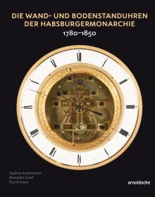 White lock face with gold mechanism, on black cover of 'Die Wand- und Bodenstanduhren der Habsburgermonarchie, 1780–1850', by Arnoldsche Art Publishers.