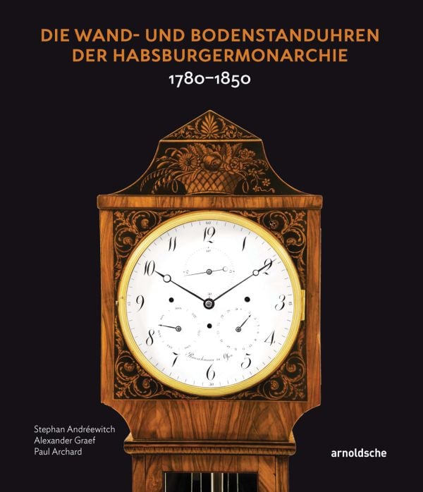 White lock face with gold mechanism, on black cover of 'Die Wand- und Bodenstanduhren der Habsburgermonarchie, 1780–1850', by Arnoldsche Art Publishers.