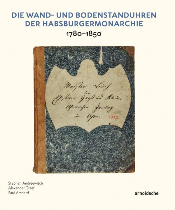 White lock face with gold mechanism, on black cover of 'Die Wand- und Bodenstanduhren der Habsburgermonarchie, 1780–1850', by Arnoldsche Art Publishers.