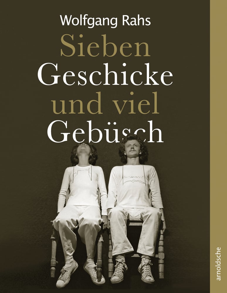 White couple in white clothes and plimsoles, sitting on wooden chairs, on brown cover of 'Wolfgang Rahs, Seven Skills and a Lot of Wilderness', by Arnoldsche Art Publishers.