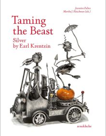 Silver sculpture of open roofed car with bird at wheel, creature balancing on orange egg to rear, on white cover of 'Taming the Beast Silver by Earl Krentzin', by Arnoldsche Art Publishers.