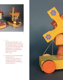 Collection of wooden toys: rocking horse and rider, tree, three geese, two folks, on cover of 'Max Schanz, Spielzeug Gestalten im Erzgebirge', by Arnoldsche Art Publishers.