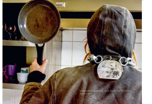 Book cover of LithoMania, Design Lab #11, with an amber jewel balancing on forehead. Published by Arnoldsche Art Publishers.