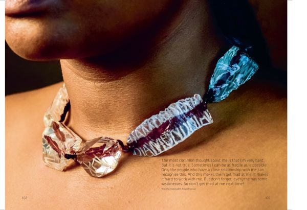 Book cover of LithoMania, Design Lab #11, with an amber jewel balancing on forehead. Published by Arnoldsche Art Publishers.