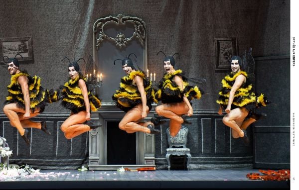 Book cover of The Scene and the Unseen, Opera in Pictures. Photographs by Monika Rittershaus, with a Opera theatre production, with three windswept figures with water splashing at feet. Published by Arnoldsche Art Publishers.