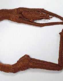 Book cover of Joyce J. Scott: Messages, with female modelling large, intricate beaded neck piece. Published Arnoldsche Art Publishers.