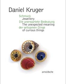 White book cover of Daniel Kruger, Jewellery – The unexpected meaning of curious things, featuring four colourful shell-shaped brooches face down. Published by Arnoldsche Art Publishers.