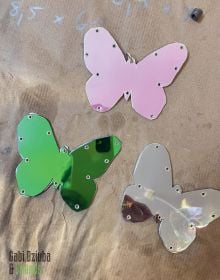 Book cover of Gabi Dziuba & Friends, with three shiny butterfly shaped pieces. Published by Arnoldsche Art Publishers.