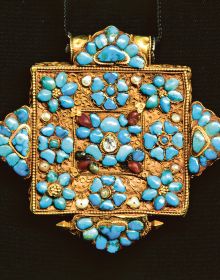 Book cover of Lynn Levenberg's Tibetan Women’s Jewelry, with a Tibetan Ga’u Box set with Turquoise and glass Dzi Beads. Published by Arnoldsche Art Publishers.