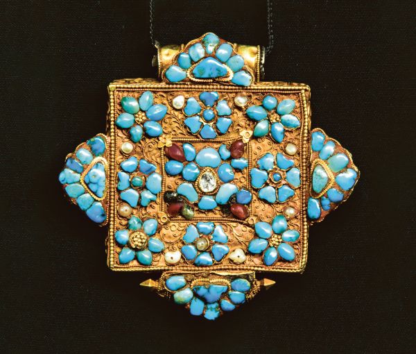 Book cover of Lynn Levenberg's Tibetan Women’s Jewelry, with a Tibetan Ga’u Box set with Turquoise and glass Dzi Beads. Published by Arnoldsche Art Publishers.