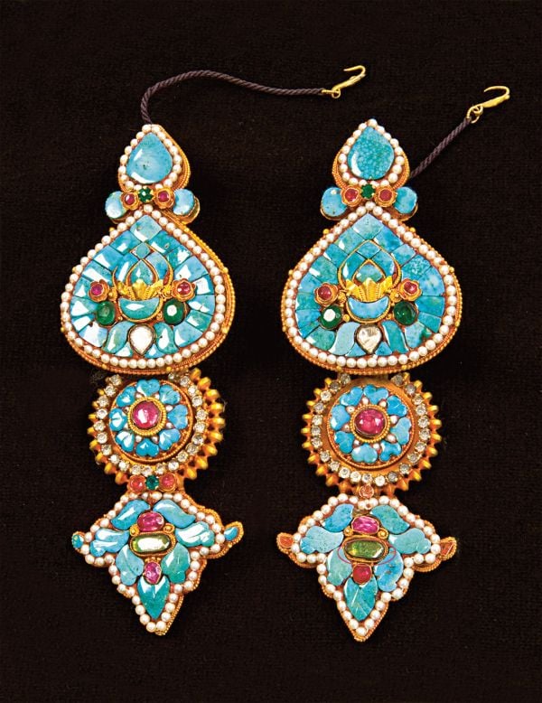 Book cover of Lynn Levenberg's Tibetan Women’s Jewelry, with a Tibetan Ga’u Box set with Turquoise and glass Dzi Beads. Published by Arnoldsche Art Publishers.