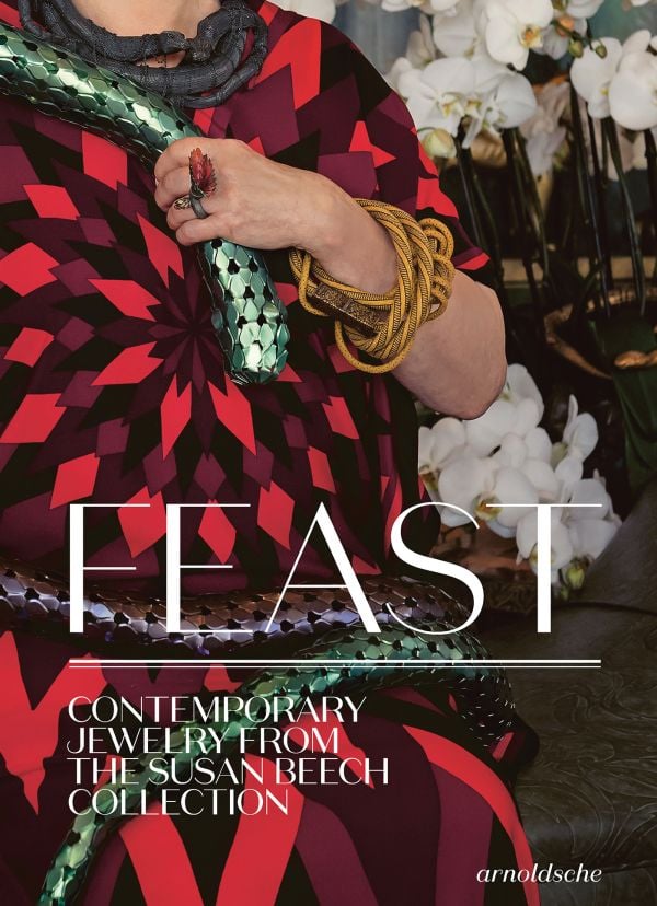 Book cover of Feast: Contemporary Jewelry from the Susan Beech Collection, featuring a figure in red dress wearing a large gold bangle made of cord. Published by Arnoldsche Art Publishers.