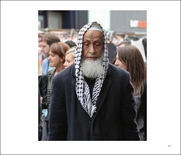 Book cover of Brick Lane in London: All the World’s a Stage: Street Photography by David and Sonya Newell-Smith, featuring two couples sitting in a cafe. Published by Arnoldsche Art Publishers.