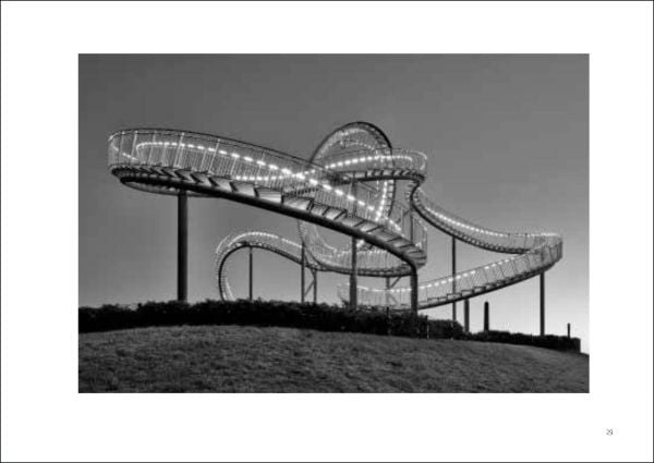 Mint green crown shaped structure tied down with rope, next to street building, on landscape cover of 'Joyful Architecture, European Architectural Photography Prize 2019', by Avedition Gmbh.