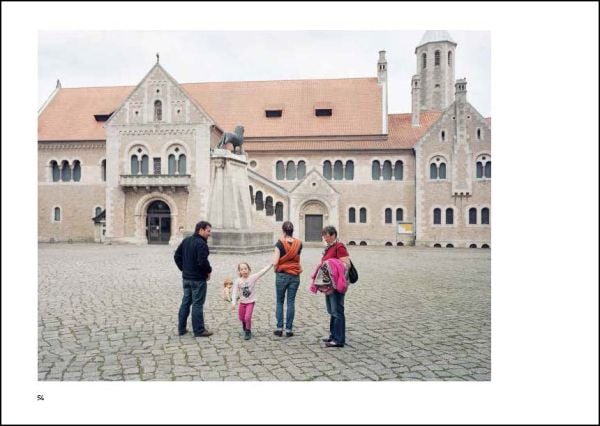 Mint green crown shaped structure tied down with rope, next to street building, on landscape cover of 'Joyful Architecture, European Architectural Photography Prize 2019', by Avedition Gmbh.