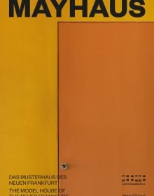 Orange door with key in lock, on cover of 'mayhaus, Das Musterhaus des Neuen Frankfurt', by Avedition Gmbh.