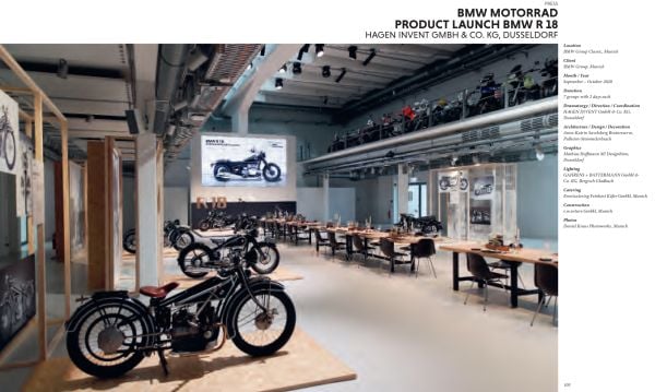 White architectural building with emojis of hearts, smiley faces, thumbs up and clapping hands, on cover of 'Event Design Yearbook, Special Edition', by Avedition Gmbh.