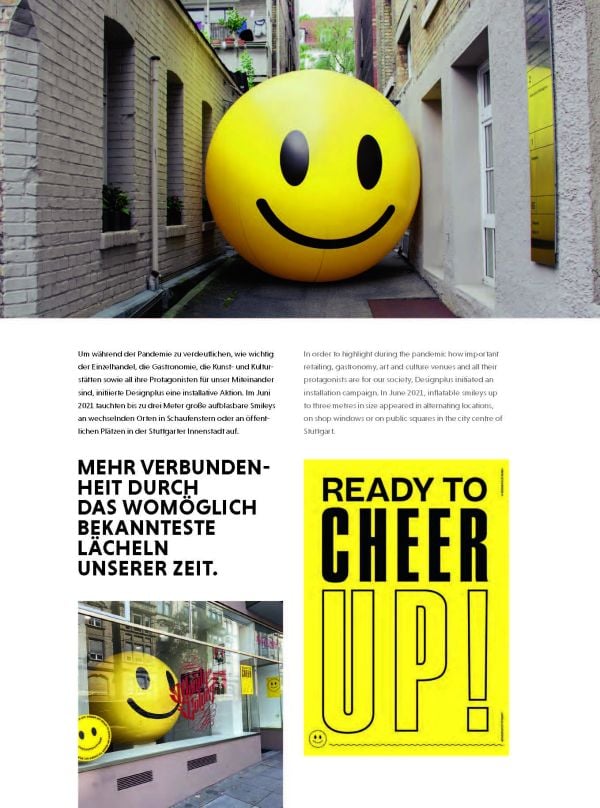 Book cover of Event Design Yearbook 2022 / 2023, with an exhibition space, and a man looking at figure with wings fighting figure with sword. Published by Avedition Gmbh.