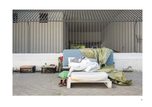 Rows of pale pink chairs with one replaced by orange and white striped traffic cone, on cover of 'Provisorium / Stopgap, European Architectural Photography Prize 2023', by Avedition.