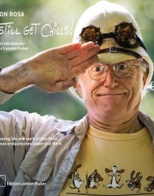 Don Rosa saluting in white pith helmet and goggles, on cover of 'Don Rosa - I Still Get Chills! by Edition Lammerhuber.