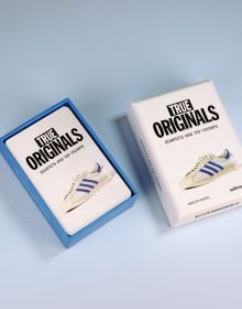 Book cover of True Originals: Quartets and top trumps, with a white adidas sneaker with blue stripes. Published by Seltmann Publishers.