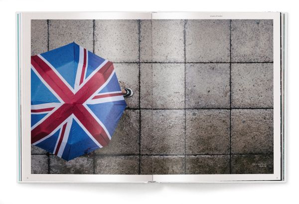 Low angled shot of aeroplane flying overhead London skyscrapers, white cover, streets of london, on black font above.