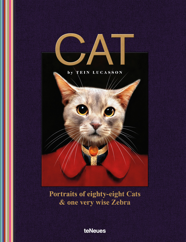 Pale fur cat wearing red jacket, navy cover, 'CAT', in gold font above, by teNeues Books.