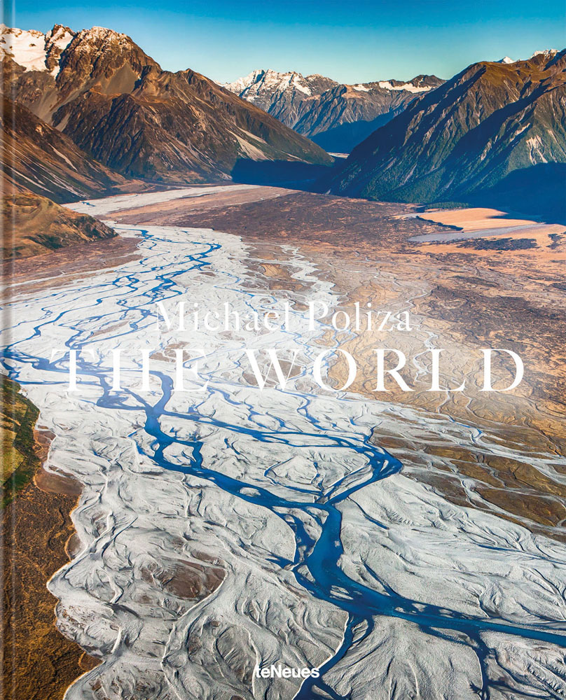 Aerial view of mountainous landscape with river, on cover of 'The World', by teNeues Books.