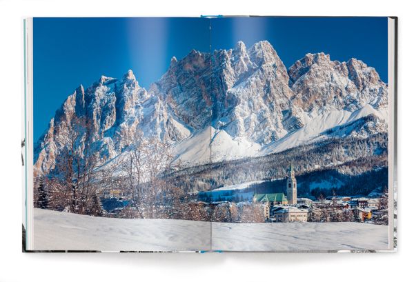 Book cover of The Ultimate Ski Book, featuring the former World Cup alpine ski racer Andreas Wenzel, with female skier. Published by teNeues Books.