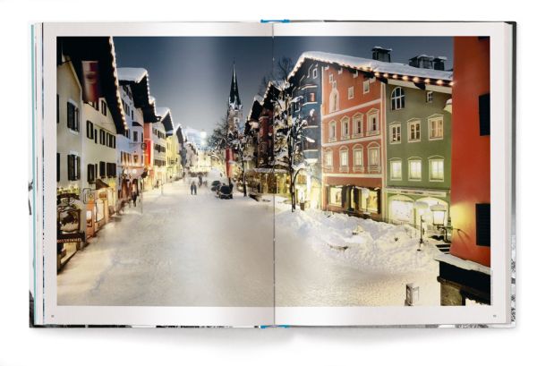 Book cover of The Ultimate Ski Book, featuring the former World Cup alpine ski racer Andreas Wenzel, with female skier. Published by teNeues Books.