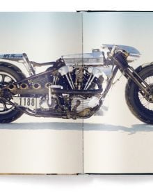 Book cover of The Harley-Davidson Book - Refueled, featuring a biker on Harley Davidson, riding through desert landscape with rocky mountains behind. Published by teNeues Books.