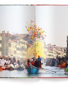 Dramatic action image of multi coloured confetti filling the air above a large crowd of people with Celebrate! in yellow font above