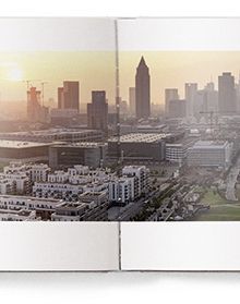 Panoramic landscape of city skyline, advancing horizons, in white font to centre right of cover.