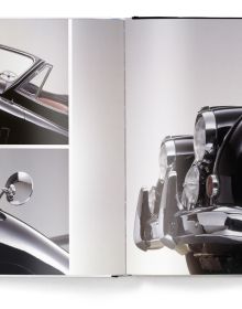 Cream Jaguar XK140 classic sports car with spoke wheels, The Jaguar Book, in black font above.