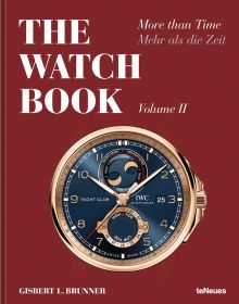 Book cover of The Watch Book: More than Time Volume II, featuring a IWC Schaffhausen Yacht Club wristwatch, new moon and tide complication, on dark blue face, with gold surround. Published by teNeues Books.
