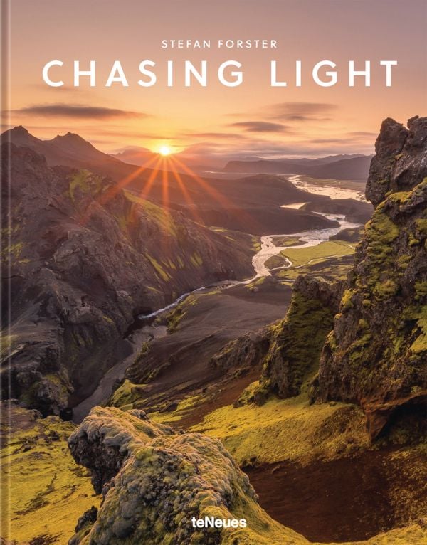 Book cover of Chasing Light, with the sun peaking through mountain landscape. Published by teNeues Books.
