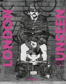 Wall grafitti of policeman sitting on a toilet, in London, LONDON UNSEEN, in pink font down either side.