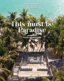 Aerial view of luxury beach resort with palm trees surrounding decked area, 'This Must be Paradise', in white font above.