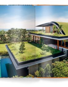 Ground perspective of 3 wood buildings with trees spurting out top, LIVING ROOFS in orange font near centre