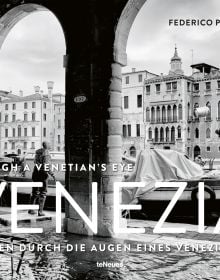 Landscape shot from under arched building, of canal in Venice with man throwing beer barrel in air, THROUGH A VENITIAN'S EYE VENEZIA in white font to lower left.