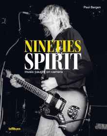 Kurt Cobain playing guitar on stage while singing, NINETIES SPIRIT, in yellow, and white font above centre of cover.