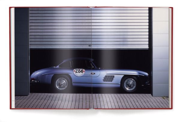 Book cover of IconiCars Mercedes-Benz 300 SL, featuring the front of red Mercedes-Benz 300 SL with open gullwing doors. Published by teNeues Books.