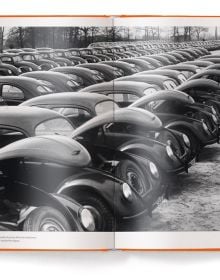 Front end of orange Volkswagen Beetle, on orange cover, ICONICARS VOLKSWAGEN BEETLE, in white font above.